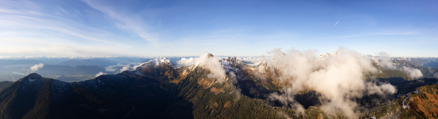 Naklejka na ściany i meble Aerial Panoramic View of Canadian Rocky Mountains with snow on top during Fall Season. Nature Landscape located near Chilliwack, East of Vancouver, British Columbia, Canada. Nature Background Panorama