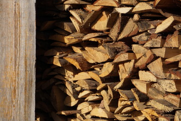 A woodpile with firewood in the village.