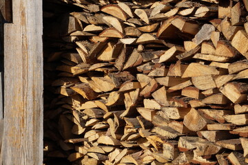 A woodpile with firewood in the village.