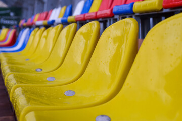 Plastic seats on sports arena after rain