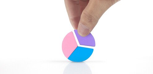 Business connecting piece of multi colored pie wood chart in hand