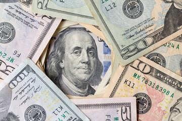 Benjamin Ben Franklin face on US 100 dollar bill closeup on banknote, United States of America...