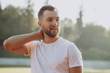 Portrait of young man standing at stadium in the morning