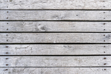 Grey timber planks background texture. Real wooden boards horizontal with rusty screws. Aged...