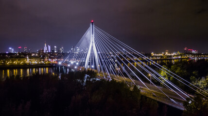 Obraz premium Night panorama of Warsaw from above, Siekierkowski bridge and downtown, photo from the drone, May 2017, Warsaw, Poland.