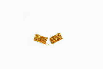 Roasted peanuts bar in a sweet molasses on a white background