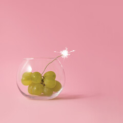 Bomb made out of green grapes in a glass set on fire.