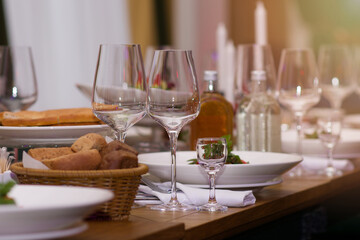 Preserved set table in the restaurant. Glasses, plates, dishes on the table. The concept of a holiday, restaurant business, cafe, dinner party. Selective focus. Copy space