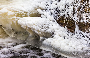 Fast river with ice and snow in late autumn