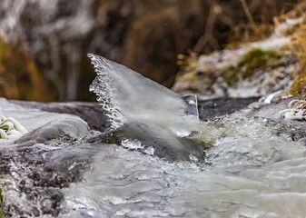 Fast river with ice and snow in late autumn