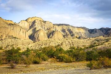 Stunning sharp edge cliffs in vashlovani national park area with beautiful colorful autumn trees and road