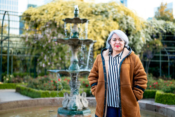 Portrait of a woman with gray hair at the park