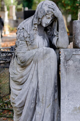 Old tombstone with mourning woman in Lychakiv cemetery in Lviv Ukraine