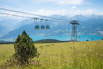 beautiful alpine landscape with Niederhorn cableway and view to lake thunersee