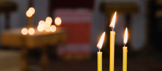 Burning candles in the church during the festive service on Christmas
