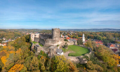 Aerial view of Bolkow Castle surrounded by yellow autumn trees, Lower Silesia, Poland © bbsferrari