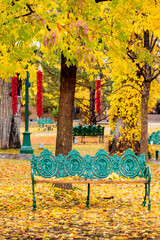 Nothing says it better than the Santa Fe Plaza dressed in autumn colors with the hanging red chili peppers or Ristras, and the colorful, artistic benches.. - 464306481