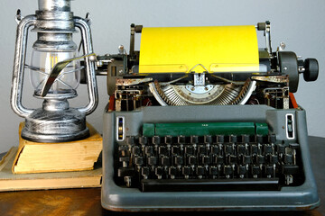 typewriter on table, words fake news are printed on paper in large size, vintage lantern shines, retro style, concept of information hoax in social media, misleading, exposing deception, old school