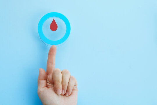 World diabetes day awareness. Woman hand with a blue circle with blood drop, symbol of the diabetes