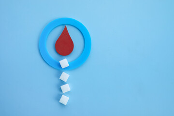 World diabetes day awareness. Blue circle with blood drop and sugar cubes.