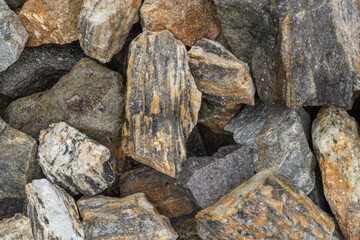 Decorative grit stone imitating tree bark. Natural decorative stone bark with golden shimmering threads as background