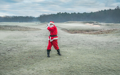 Santa Claus as a golfer in motion.