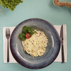 Fresh pasta and ingredients. pasta with cheese in a dark plate