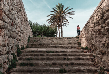 Girl on top of ancient stone stairs outdoors