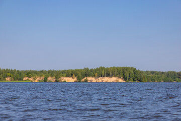 Beautiful view of the Unzha river with pine forest. Kostroma region. Summer tourist landscape.