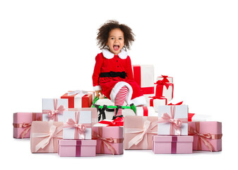 Little African-American girl in Santa costume, with sledges and gifts on white background