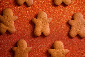 gingerbread man on bright orange christmas background with space