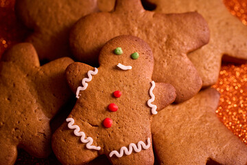 gingerbread man on bright orange christmas background with space