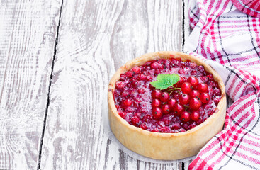 Freshly baked red currant pie on white wooden table