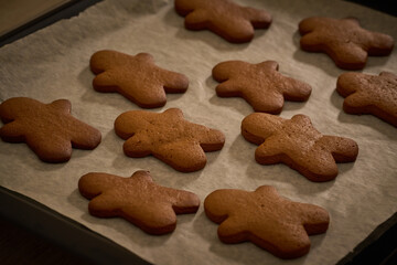 gingerbread men on the baking tray warming up