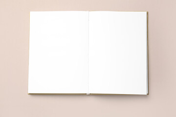 Blank open notebook on color background