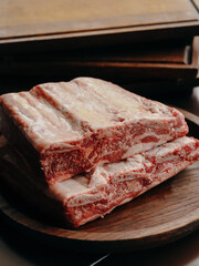 Fresh ribs ready for cooking on a wooden plate