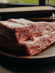 Close up of fresh ribs ready for cooking on a wooden plate