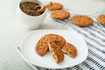 Plate with tasty hojicha cookies on light background
