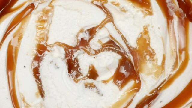 Caramel Ice Cream Rotates On The Table. Top View. Close Up