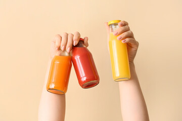 Female hands with glass of healthy juice on color background