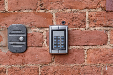 old intercom at the entrance to a residential building