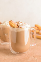 Glass cup of tasty Tiramisu Latte on table