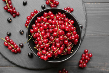 Composition with ripe red currant on dark wooden background, closeup