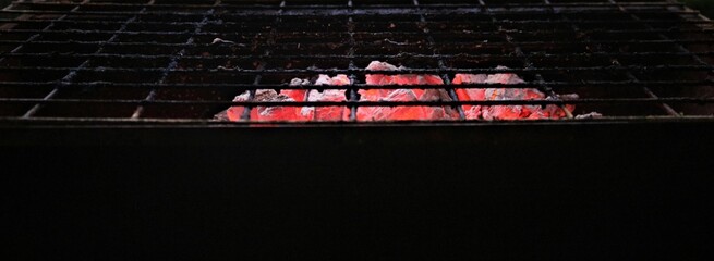 burning charcoal under the grid