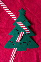 christmas tree with striped ribbon on red flet © eugen