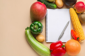 Blank notebook, pen, fruits and vegetables on color background. Vegan Day