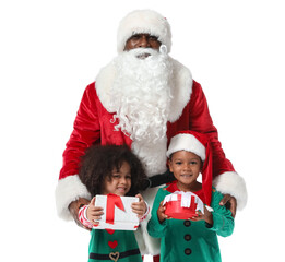 Little African-American children dressed as elves with Santa Claus and gifts on white background