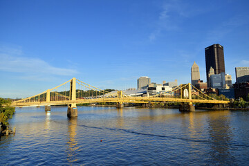 Bridges crossing the Allegheny River in Pittsburgh reflecting the early evening sun. In the...