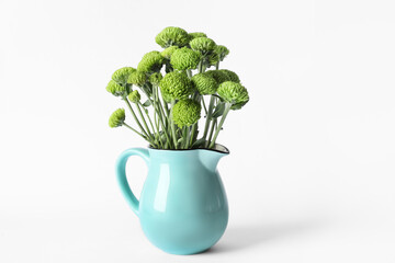 Jug with beautiful green chrysanthemum flowers on white background