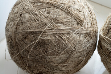 A ball of gray thin threads intended for yarn fabrics